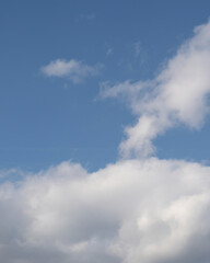 Clouds in the sky over a clear blue background during daytime