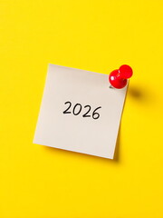 a sticky note with 2026 text on yellow background