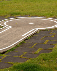 Design of a key shape on a park surface with grass and stones during the daytime