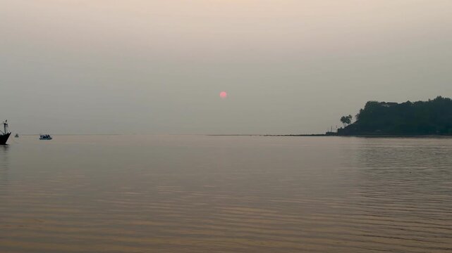 Sunset over the Arabian Sea in Panaji Goa India, calm coastal landscape at dusk
