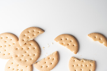 Broken round biscuits on white background with copy space