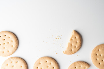 Simple biscuit texture pieces scattered on clean white surface