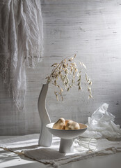 Still life with a bouquet of cereals and pumpkins on a light background