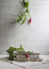 An ironic still life with radishes on a light background