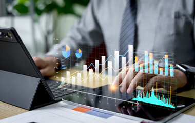 Marketing team reviews business data on a dashboard, analyzing graphs and reports to perform planning activities and express strategic decision making through data driven insights.