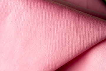 Pink textile background with smooth woven texture