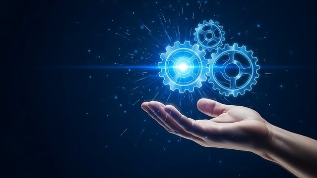 Hand holding glowing blue gears with light effect on dark background