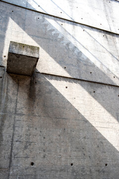 Concrete wall with abstract geometry brutalism detail and rich texture in light and shadow expressing minimalism through strong graphic form