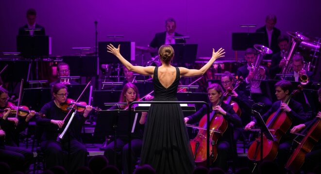 Female Conductor Leading an Orchestra on a Purple-Lit Stage with Musicians Playing Instruments