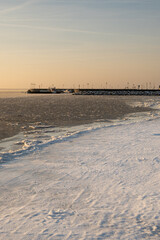 Fototapeta premium Winter coastline of Hel Peninsula with frozen Baltic Sea. Kuznica village in Poland, Europe