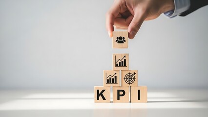 Businessman building kpi pyramid with wooden blocks and graphs