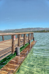 Fototapeta premium A wooden pier with a red sign on it