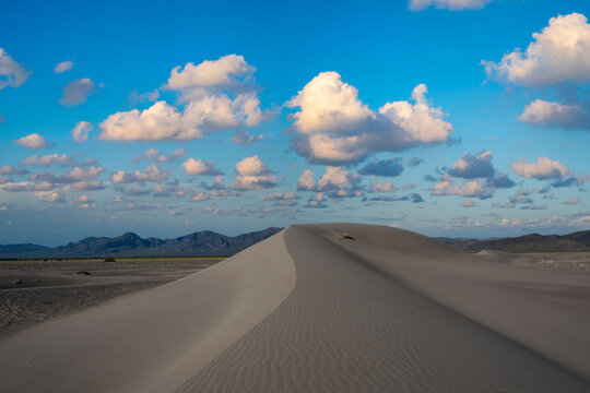 Cloudy sky over a large sand dune in Nevada 