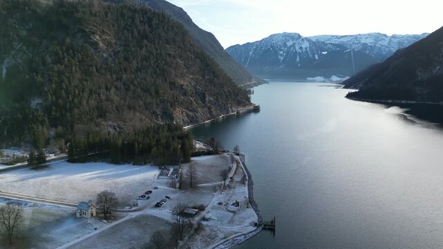snow covered mountain lake achensee in austria with pertisau winter landscape