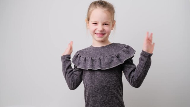 Portrait of preeten girl kid smelling something stinky and disgusting, intolerable smell, holding breath with fingers on nose, hand gesture isolated. Bad smell concept