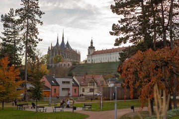 Fototapeta premium Happy family with children and dog in Kutna Hora, Czech Republic, visiting the town on an autumn sunny day