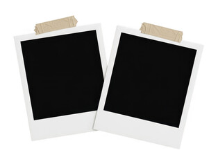 Two blank white polaroid with tape isolated on a transparent background