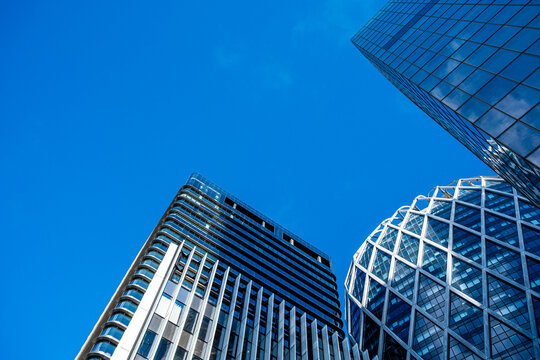 Blue geometric paris city skyline with modern architecture skyscraper glass tower rising upward under bright sky for corporate business finance