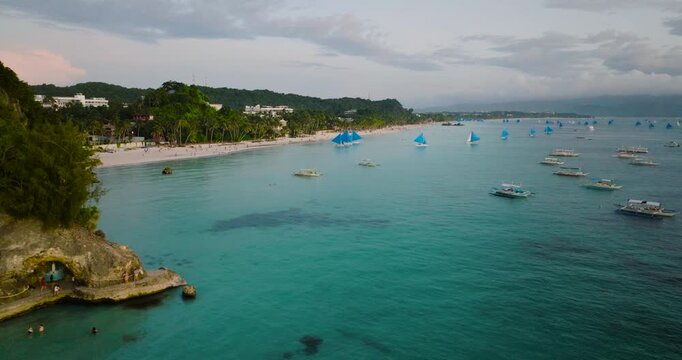 White beach and turquoise water with tourist boats. Boracay, Philippines.