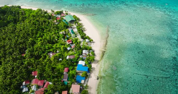 Houses in coastal area of Logbon Island. White sand beach in Romblon, Philippines.
