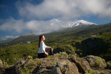 Fototapeta premium Woman Contemplating Majestic Snow-Capped Volcano Amid Lush Green Hills in Tenerife, Canary Islands