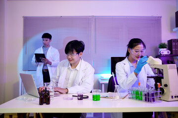 A team of scientists collaborating over data charts and lab results, Dedicated scientists collaborating on groundbreaking research in a modern laboratory environment