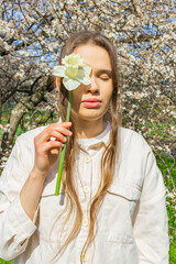 Young woman holding a bouquet of daffodils in her hands