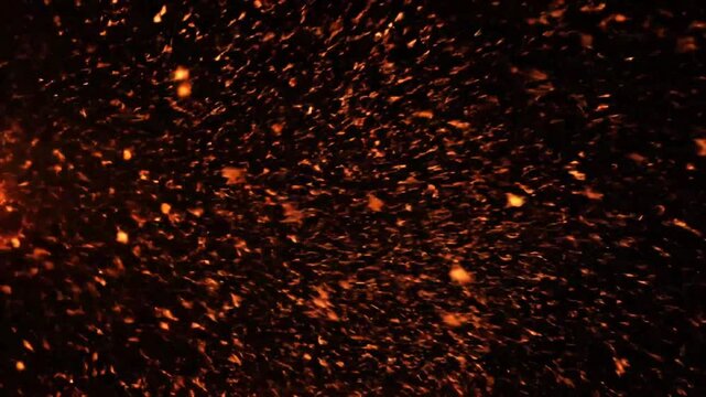 Explosive Ember Showers and Fiery Particle Trails Against a Dark Backdrop