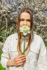 Young woman holding a bouquet of daffodils in her hands