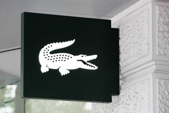 Berlin, Germany - July 13, 2020: Lacoste logo on a wall. Lacoste is a French clothing company, founded in 1933 by tennis player Rene Lacoste	