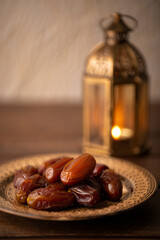 Glossy Dates on Wooden Plate with Glowing Lantern Background, Ramadan Kareem Iftar, Jumma Mubarak Blessings, Traditional Fast-Breaking Meal