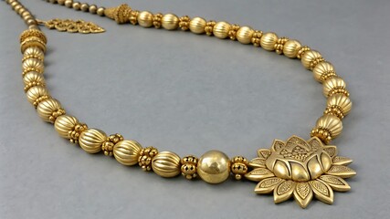 Obraz premium Intricate gold necklace with floral pendant and beaded chain