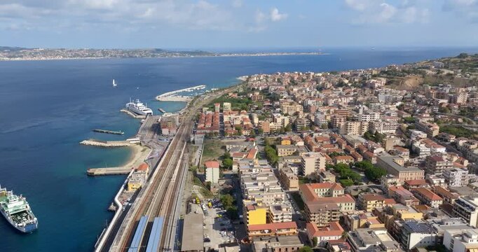 Aerial panoramic view of Villa San Giovanni, located in the Metropolitan City of Reggio Calabria, Italy. It is a port city overlooking the Strait of Messina. Across the sea is the coast of Sicily.