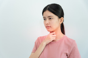 Fototapeta premium Asian woman put on neck due to a sore throat. female tonsillitis causes a inflammation. treated by taking water, taking antibiotics, consult a doctor, virus, corona virus, Influenza, flu