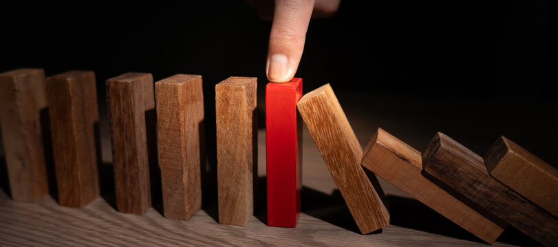 insurance with hands protect domino. Businessman hands stop dominoes falling in business crisis. business risk control and planning and strategies to run prevent insurance businesses.