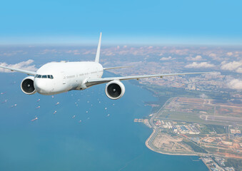 Naklejka premium Passenger airplane landing to airport -Airplane taking off from Changi Airport - Passenger airplane is flying over amazing sea - Commercial Tankers and container ships wait in the Straits of Singapore