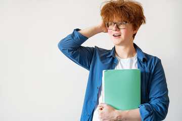 Student boy with messy red hair very surprised and excited