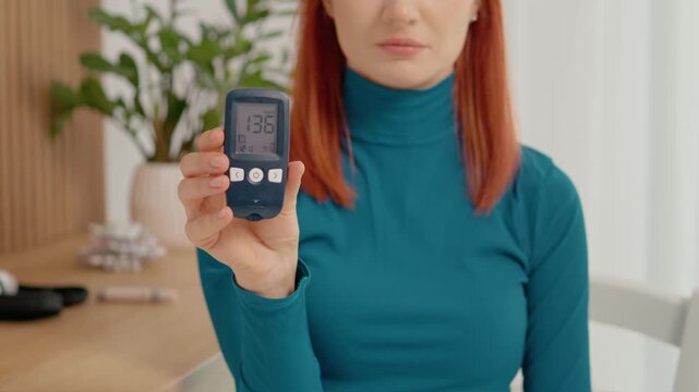 A woman holds a glucometer reading showing 136 mg dL. This result indicates high blood sugar levels. She discusses its impact on health and lifestyle choices.