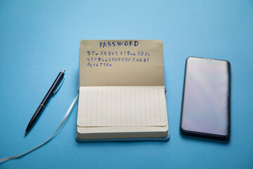 Password on paper with a pen and smartphone.