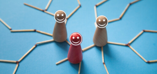 Wooden human figures with a smiley faces.