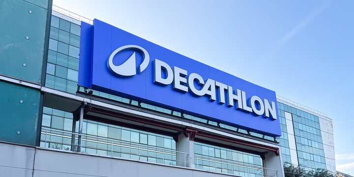 Low angle view of the large Decathlon logo on the glass and steel facade of the retail store