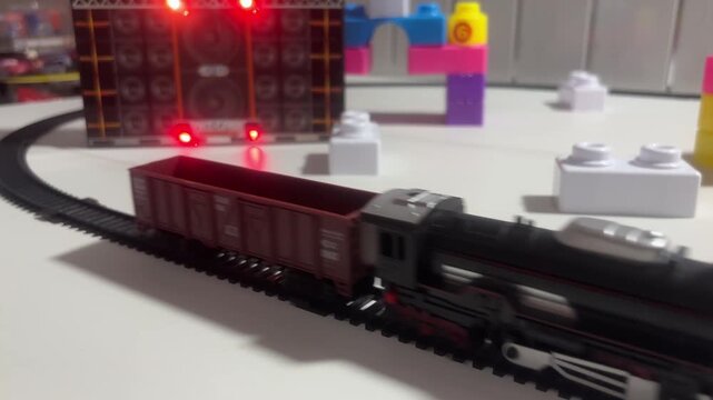 Toy Train Moving Through Colorful Track with Blocks and Play Structures