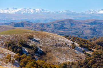 Beautiful view of peaks of the Main Caucasian Range and grassy foothills