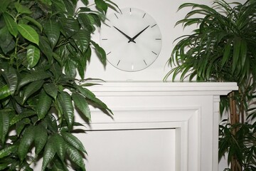 Analog wall clock redesigned with digital glow accents on minimalist futuristic wall