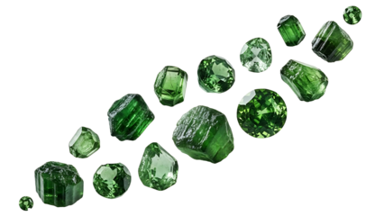 This image showcases a diverse assortment of green gemstones, varying in size, shape, and cut, arranged in a scattered pattern against a pristine white background. The gemstones exhibit a range