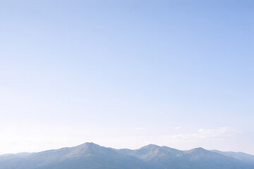 A low mountain ridge beneath an expansive open sky, designed specifically for headlines, banners, and website hero sections