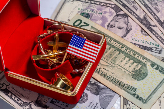 amrican flag, dollar bills and several types of gold