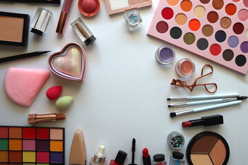 Various colorful cosmetic products on white background. Flat lay.