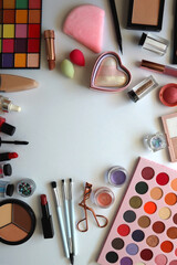 Various colorful cosmetic products on white background. Flat lay.
