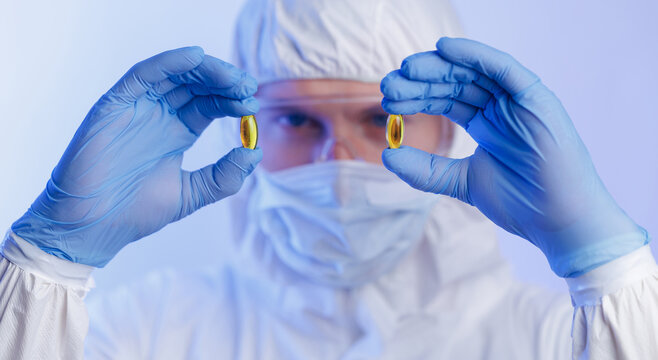 Medical production, worker inspects pill capsules quality in pharmaceutical facility